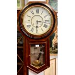An American Ansonia Regulator wall clock, octagonal case, white dial, bold Roman numerals, 30 hour