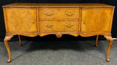 A mid 20th century burr walnut, inverted breakfront sideboard, made for Hille of London, finely