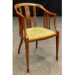 An Edwardian inlaid mahogany salon chair, serpentine front, tapered supports, 84cm high, 53.5cm