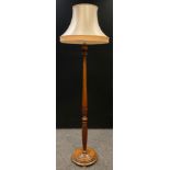A turn of century mahogany standard lamp, turned, carved and reeded column, disc base, 193cm tall.