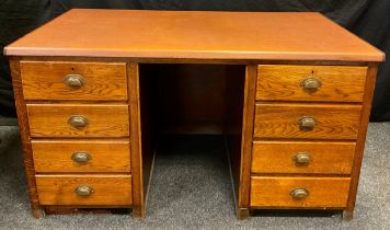 An early 20th century oak pedestal desk, faux tan leather top, each pedestal with four drawers,