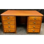 An early 20th century oak pedestal desk, faux tan leather top, each pedestal with four drawers,