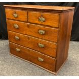 A George III oak chest, two short over three graduated long drawers, brass swing handles and