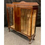 An Edwardian mahogany china display cabinet, serpentine top with gadrooned border, pair of glazed