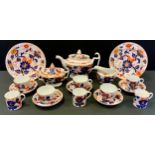 An early 19th century tea set, probably Coalport, teapot, sucrier and milk jug, assorted cups,