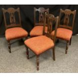 A set of four early 20th century mahogany dining chairs, over stuffed seats, turned fore legs