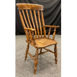 A late 19th century lathe back farmhouse kitchen chair, beech wood back and arms, elm seat and