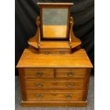 An Arts and Crafts style dressing chest, rectangular mirror with dental cornice, shaped supports,