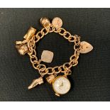 A 9ct gold and yellow metal charm bracelet, set with eight charms inc Venus 20 micron gold plated