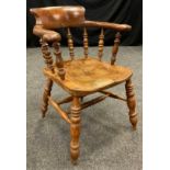 A late 19th century Elm and Oak Smoker’s bow chair, figured elm back rest, turned spindles, double