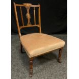 A Victorian carved and inlaid mahogany nursing chair, shaped cresting, floral inlaid central