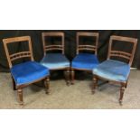 A set of four Victorian red walnut bar back dining chairs, blue upholstered seats, turned fore legs,