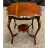 An Edwardian mahogany centre table, serpentine shaped circular top, carved legs, shaped under-