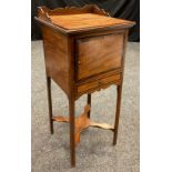 A 19th century walnut and mahogany pot stand, three quarter galleried top, over a cupboard and small