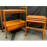 Mid 20th century design - a White and Newton teak drinks trolley, c.1960/70; a nest of three teak