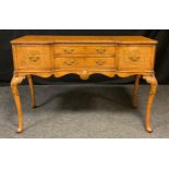 A mid 20th century burr walnut, small sideboard, made for Hille of London, inverted break front,