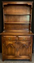 A Bevan Funnell oak dresser, plate-rack top, two drawers over pair of panelled doors to base,