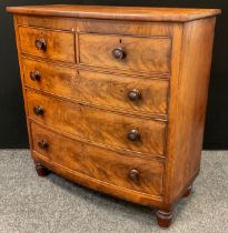 A Victorian mahogany bow-front chest of drawers, two short over three graduated long drawers, turned
