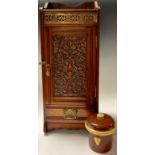 A Victorian Arts and Crafts oak smokers cabinet, 48cm high; a tobacco jar (2)