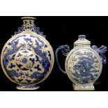 A Chinese blue and white moon flask, painted with dragons chasing the flaming pearl, dragon handles,