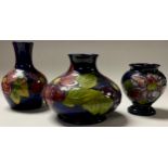 A Moorcroft Clematis pattern compressed ovoid vase, 11cm, impressed marks, monogrammed; a similar