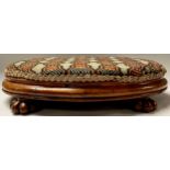 A Victorian walnut and needlework oval stool, 40cm wide