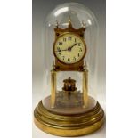 A Gustav Becker brass torsion clock, with glass dome, 30cm high overall