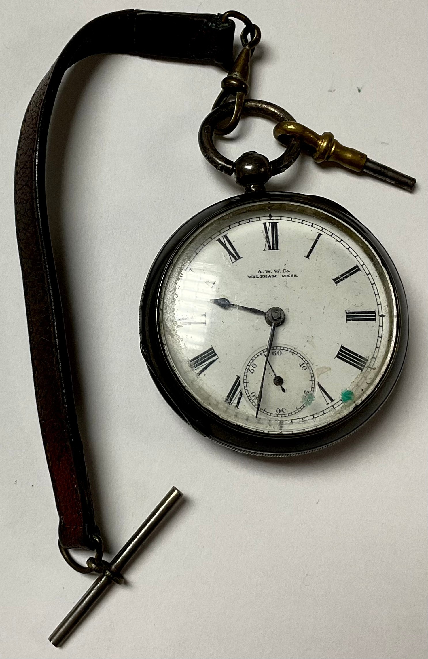 A hallmarked silver Waltham pocket watch on Albert, with key