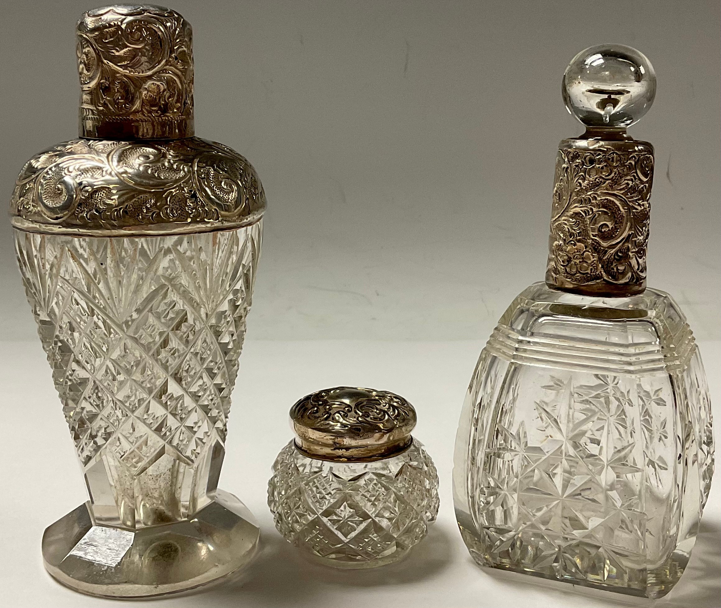 An Edwardian silver mounted scent bottle, Birmingham 1909; another; a silver mounted rouge pot (3)