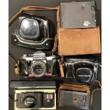 A Praktica Super TL 35mm camera, cased; an Olympus XA 2 35mm camera, boxed; a Kodak A127 camera,