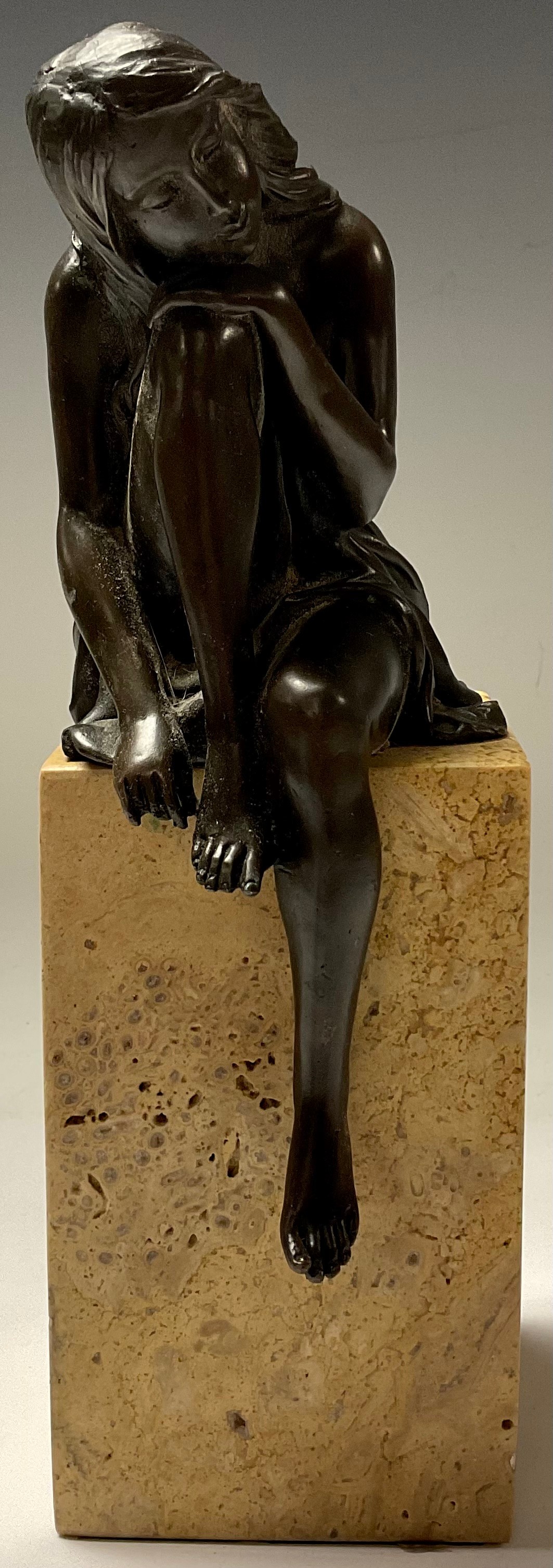 A bronze sculpture, of a seated girl, signed Milo, rectangular marble base, 27cm high