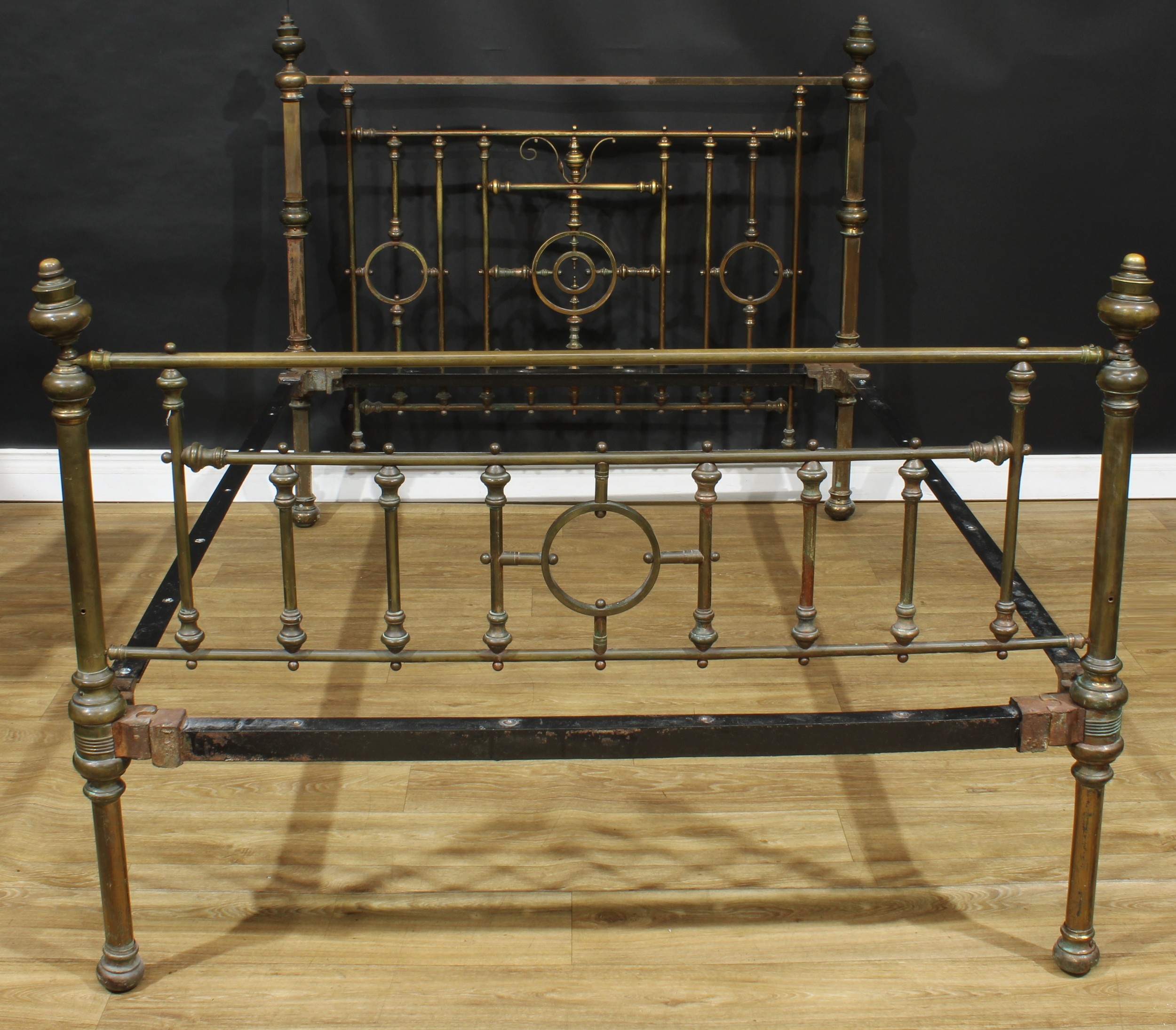 A late Victorian Aesthetic Movement bed, the headboard 124cm high, the internal dimensions 138cm x