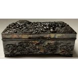 A late 19th/early 20th century Japanese pewter jewellery box, cast with foaming waves and birds in