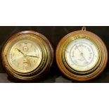 An associated pair of early 20th century brass porthole clock and barometer, each with stepped oak