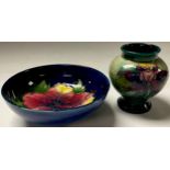 A Moorcroft Orchid pattern miniature pedestal ovoid vase, 9cm, impressed marks; a Moorcroft Hibiscus