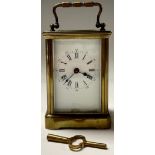 A late 19th century lacquered brass carriage timepiece, white enamel dial, Roman numerals, five