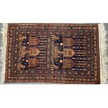 A woollen rug, decorated with temples, in shades of brown and blue, 150cm x 92cm