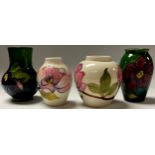 A Moorcroft Clematis pattern miniature ovoid vase, 11cm, another similar, 11cm; two Moorcroft