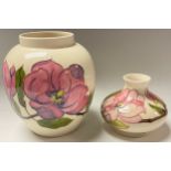 A Moorcroft Magnolia pattern ovoid vase, 19cm, dated 1980; a Moorcroft Magnolia pattern compressed