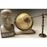 A replica phrenology bust, after L.N. Fowler, 29cm high; an articulated library magnifying glass;