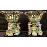 A pair of large Sitzendorf porcelain table centrepieces, the shaped circular openwork baskets