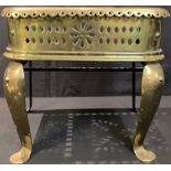 A 19th century brass footman, pierced top, steel base, 37cm wide, c.1840