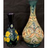 A Moorcroft bottle vase, tube lined with narcissus type flowers and tendrils, numbered 356, 23.