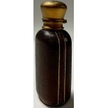 A 19th century burnished gilt metal and tooled leather scent bottle, hinged cover enclosing a