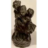A dark patinated bronze figure group, two young girls, 17cm, marked "Copyright", 20th century