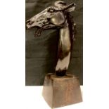 A dark patinated bronze equestrian study, bust of a horse, mouth open, mane swept behind, tapering