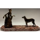 A French Art Deco spelter figure group, dainty lady in 18th century dress with a mastiff dog, shaped