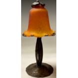 A French wrought iron table lamp, opaque speckled orange glass fluted shade, leafy finial, 31cm high