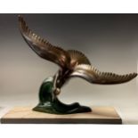 A French Art Deco spelter model of a stylised seagull in flight over a cresting wave, rectangular