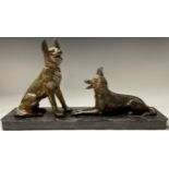 A French Art Deco spelter dog group, pair of Alsatian dogs at rest, canted rectangular black